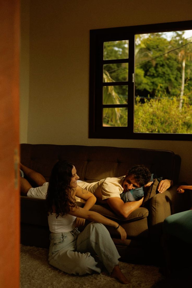 Golden-hour living room, relaxed couple on the floor