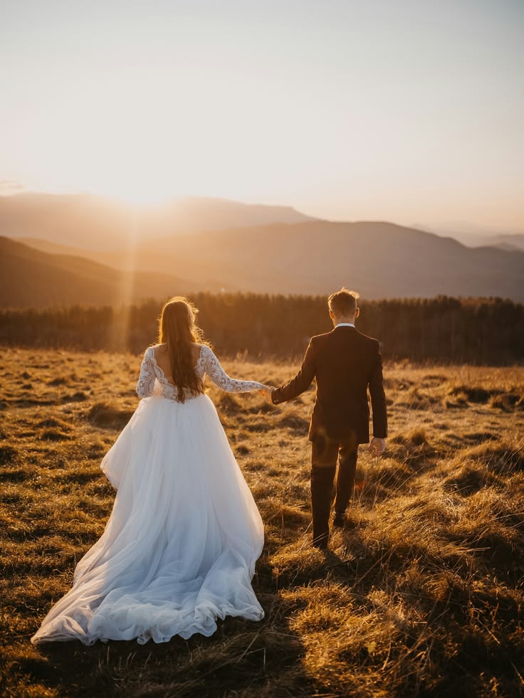 Full lace gown with a dark tailored suit at mountain sunset