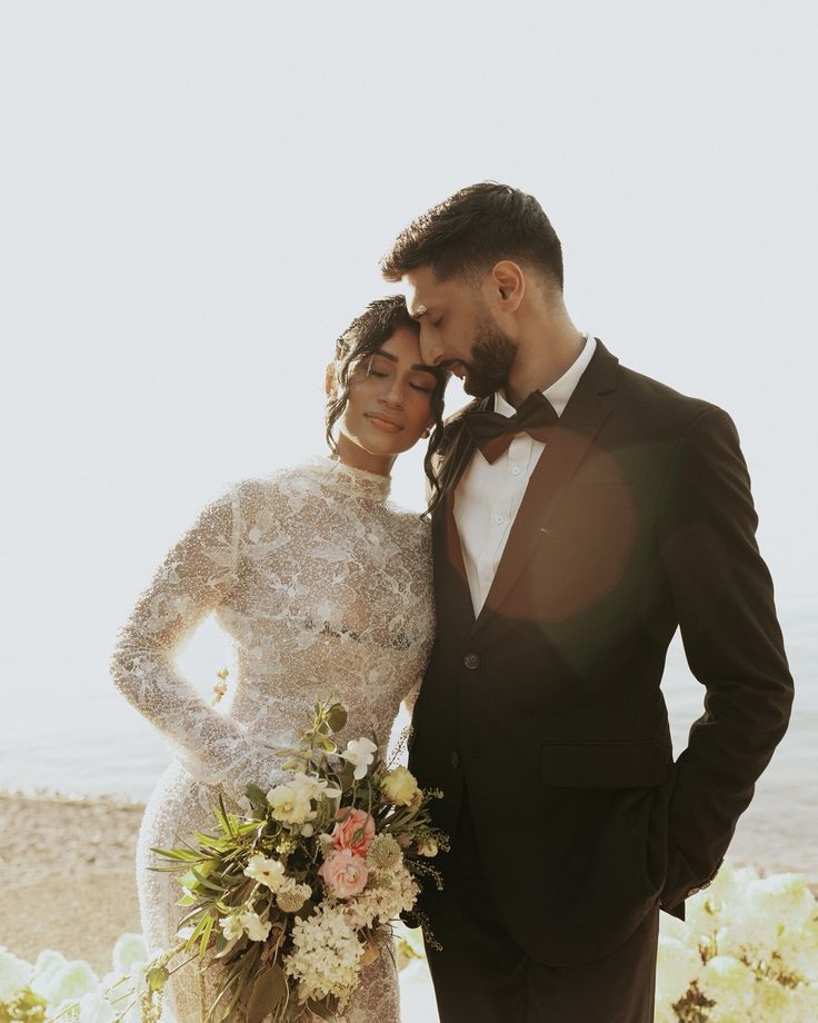 Sheer lace high-neck gown with a black tuxedo and bow tie