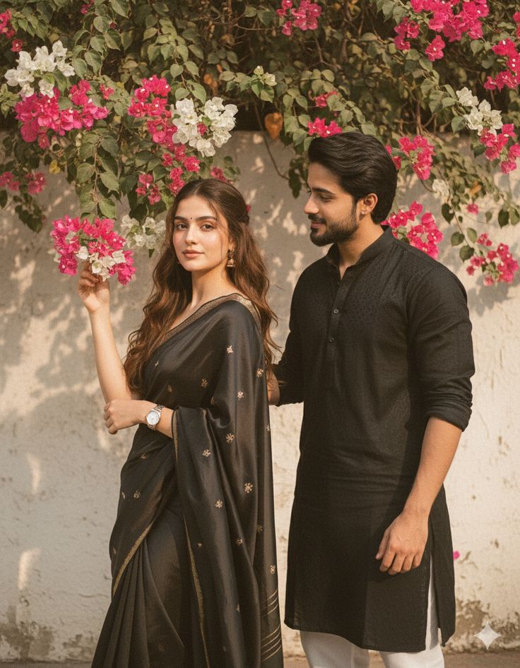 Charcoal saree with gold details and black kurta against bougainvillea