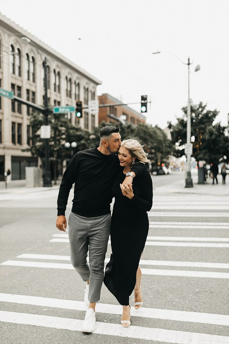 Candid couple crossing the street in all-black city outfits