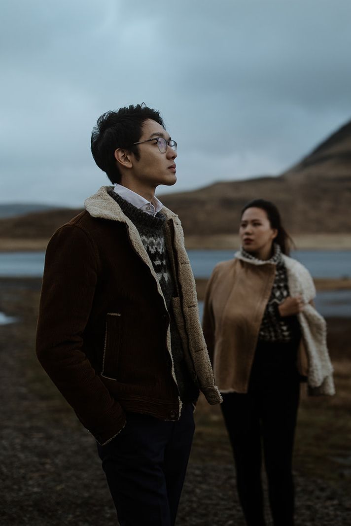 Shearling-lined jackets and patterned knits in a moody lakeside landscape